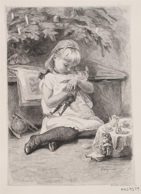 En lille pige, der leger under et juletræ